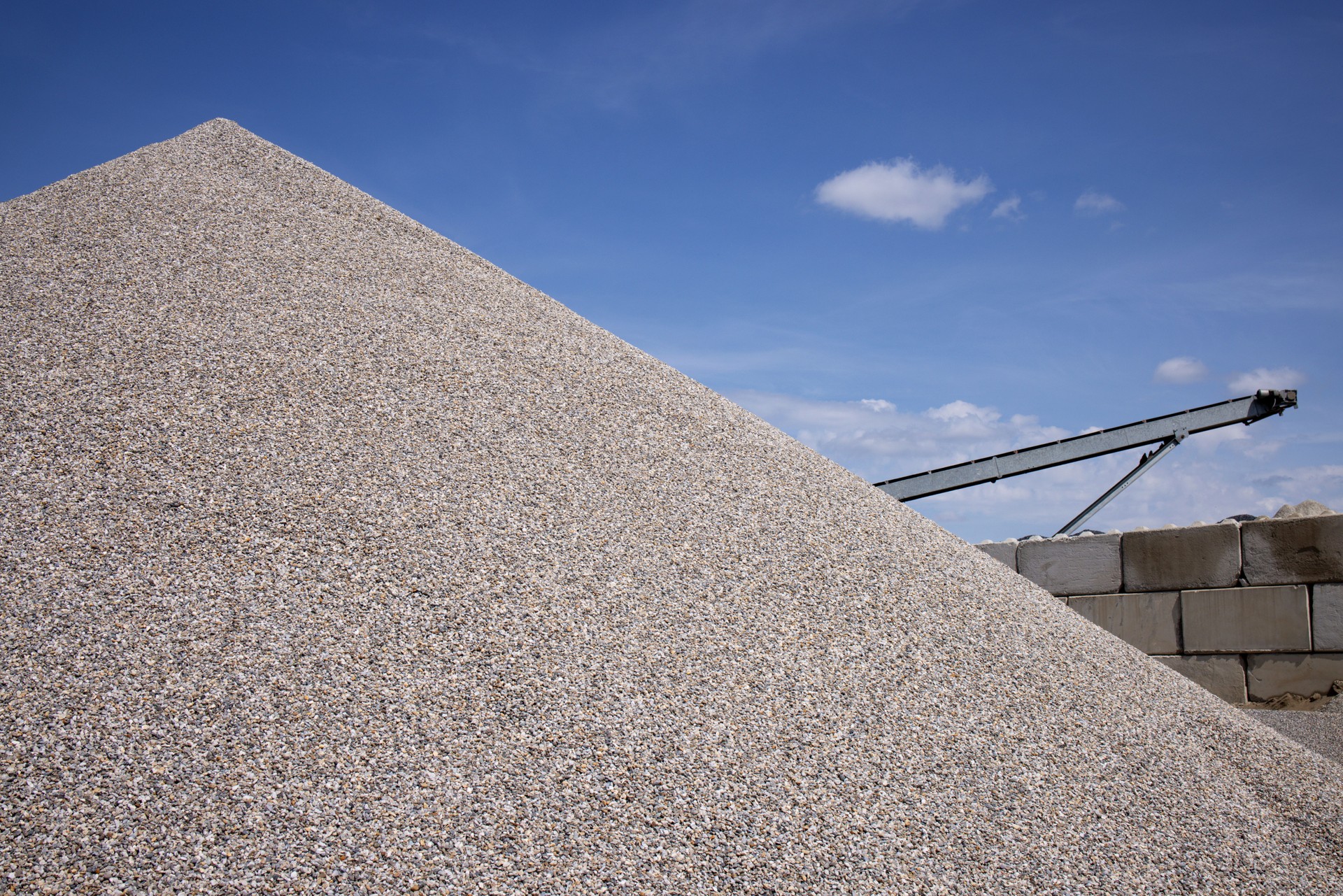 Pyramid of sorted light rubble against a blue sky background